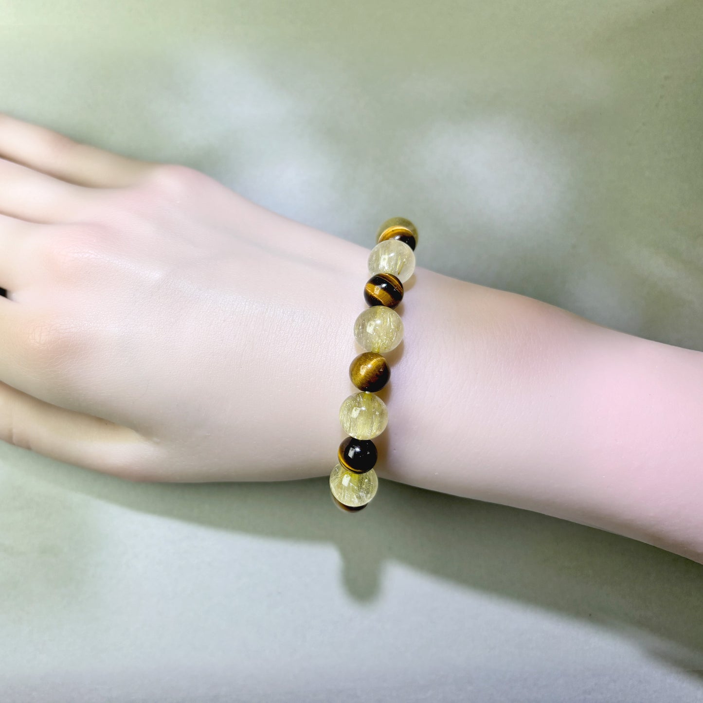 Golden Rutilated Quartz and Tiger’s Eye bracelet worn on wrist for staying focused on one path