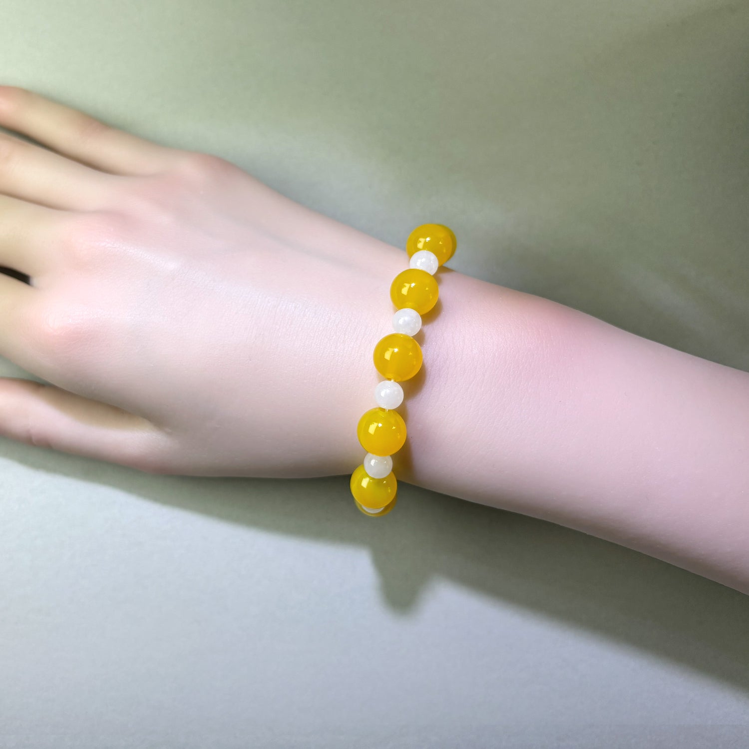 Yellow Agate and White Hetian Jade bracelet worn on wrist for a steadier and more reflective internal state
