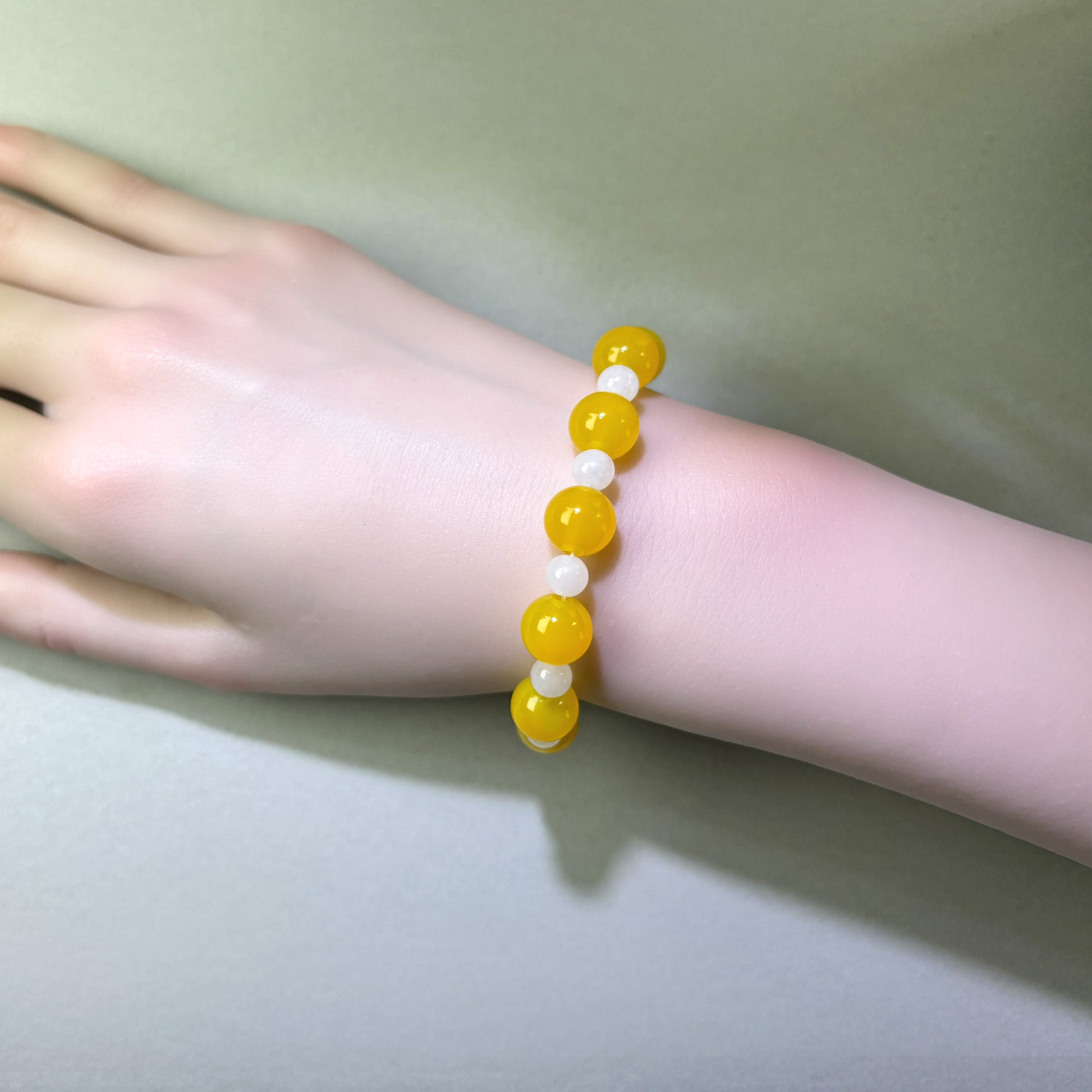 Yellow Agate and White Hetian Jade bracelet worn on wrist for a steadier and more reflective internal state