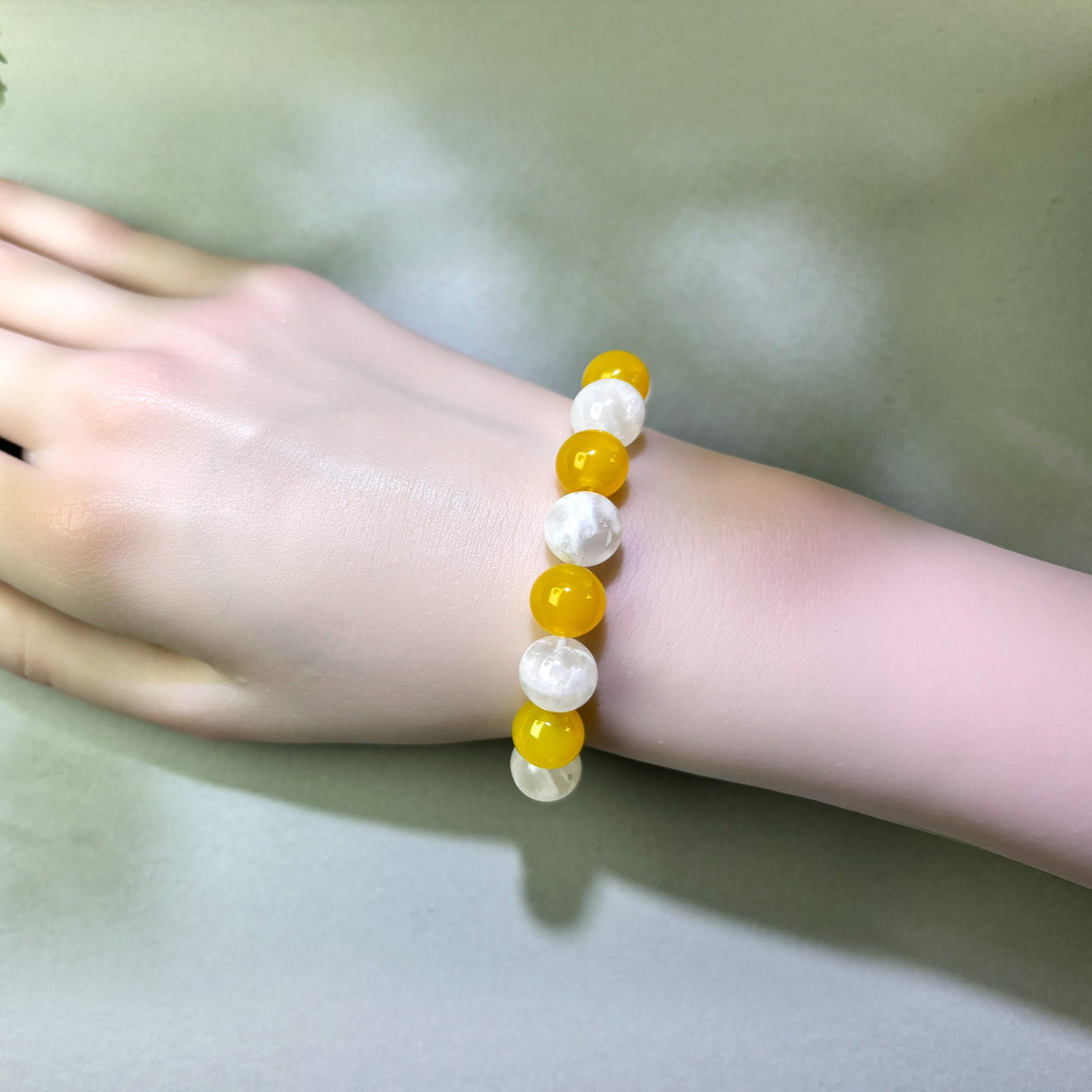 Yellow Agate and White Phantom Quartz bracelet worn on wrist for restoring balance and a steadier pace