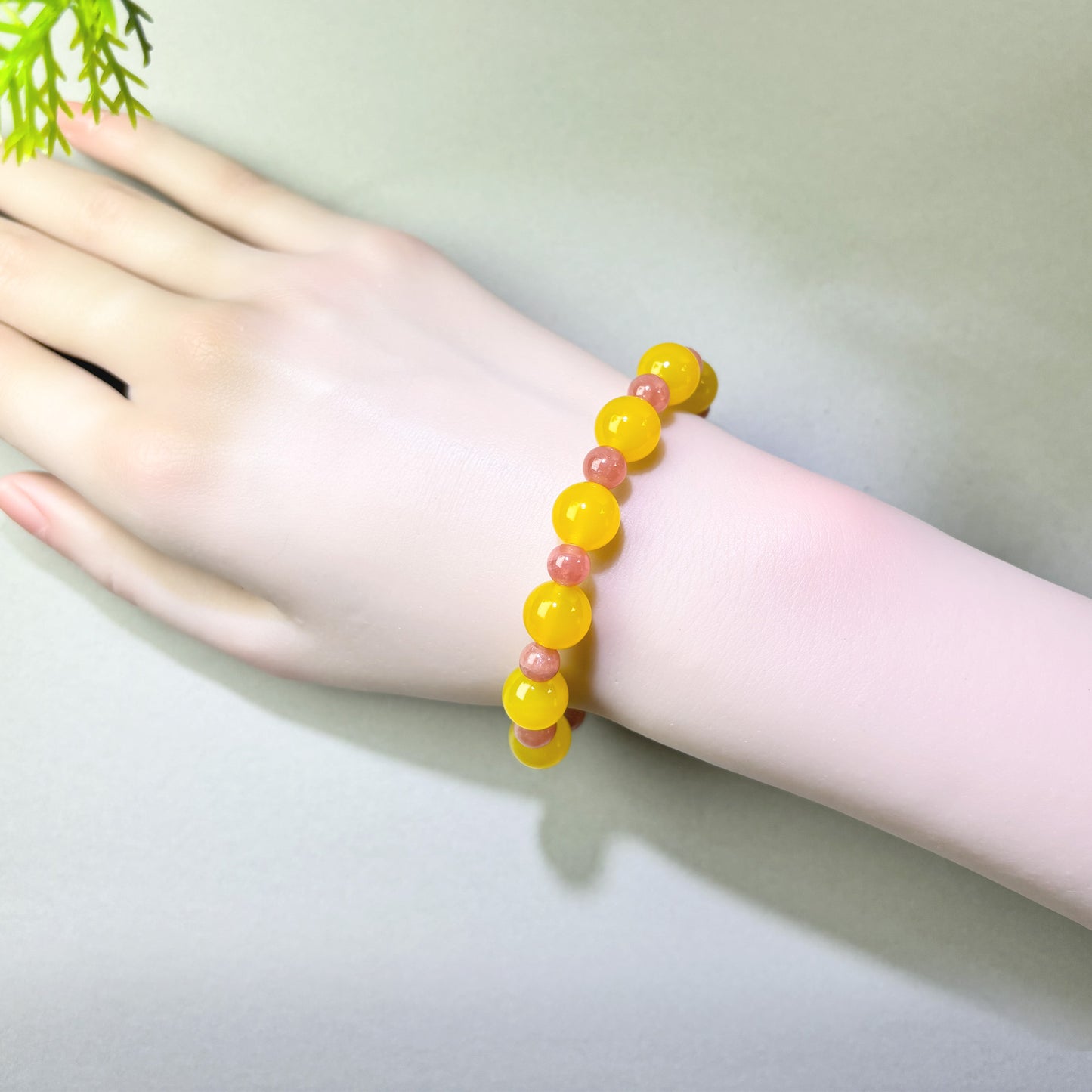 Yellow Agate and Rhodochrosite bracelet worn on wrist for emotional reconnection and moving forward
