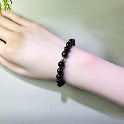 Garnet and Black Tourmaline bracelet worn on wrist for grounded inner safety and emotional warmth