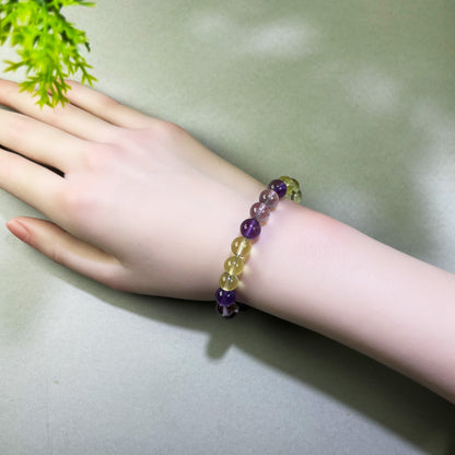 Amethyst and Citrine bracelet worn on wrist for trusting decisions and moving forward with greater confidence