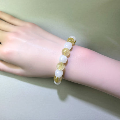 Golden Rutilated Quartz and White Hetian Jade bracelet worn on wrist for more grounded decisions and less automatic overgiving