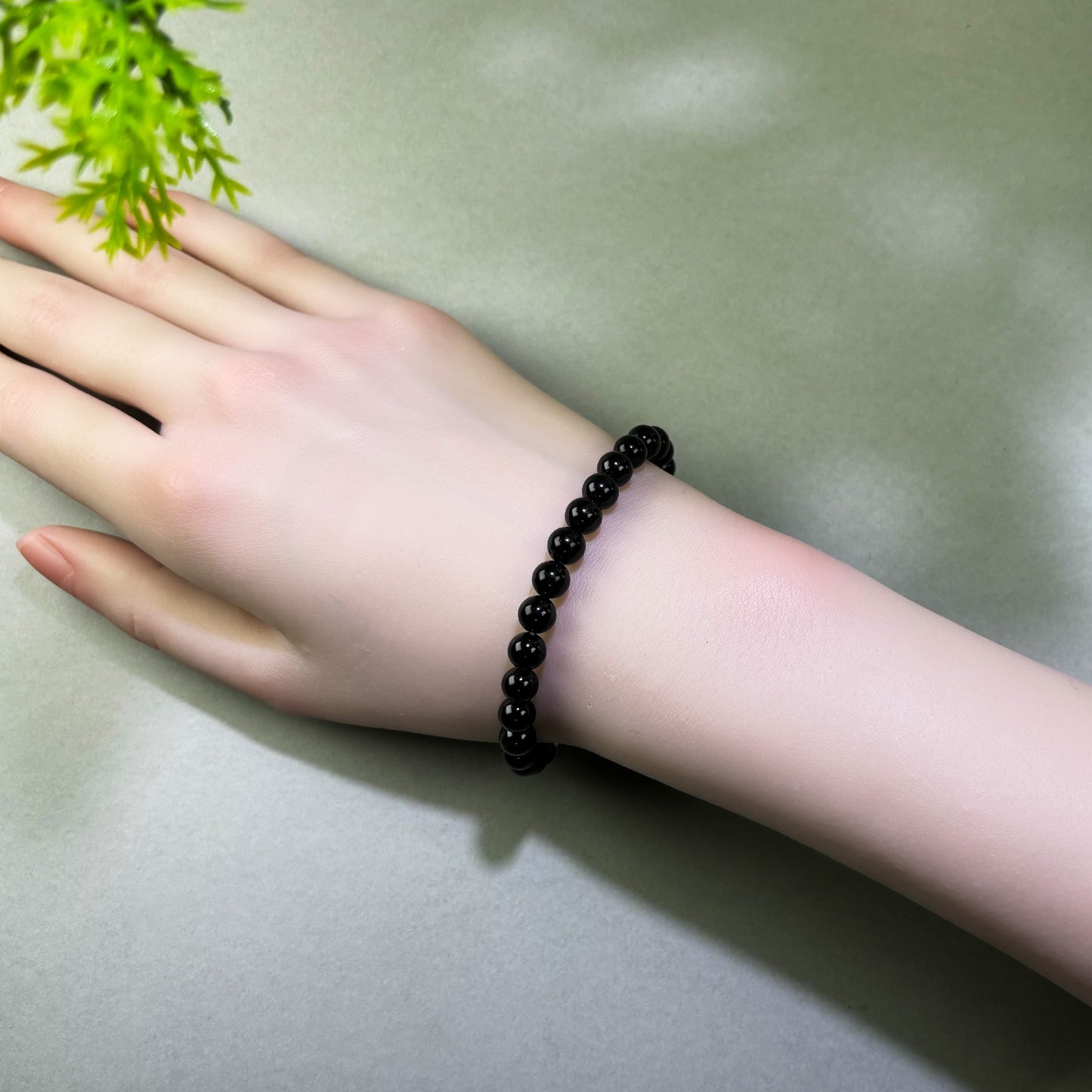 Black Tourmaline and Obsidian bracelet worn on wrist for daily protection and releasing stress after intense interactions