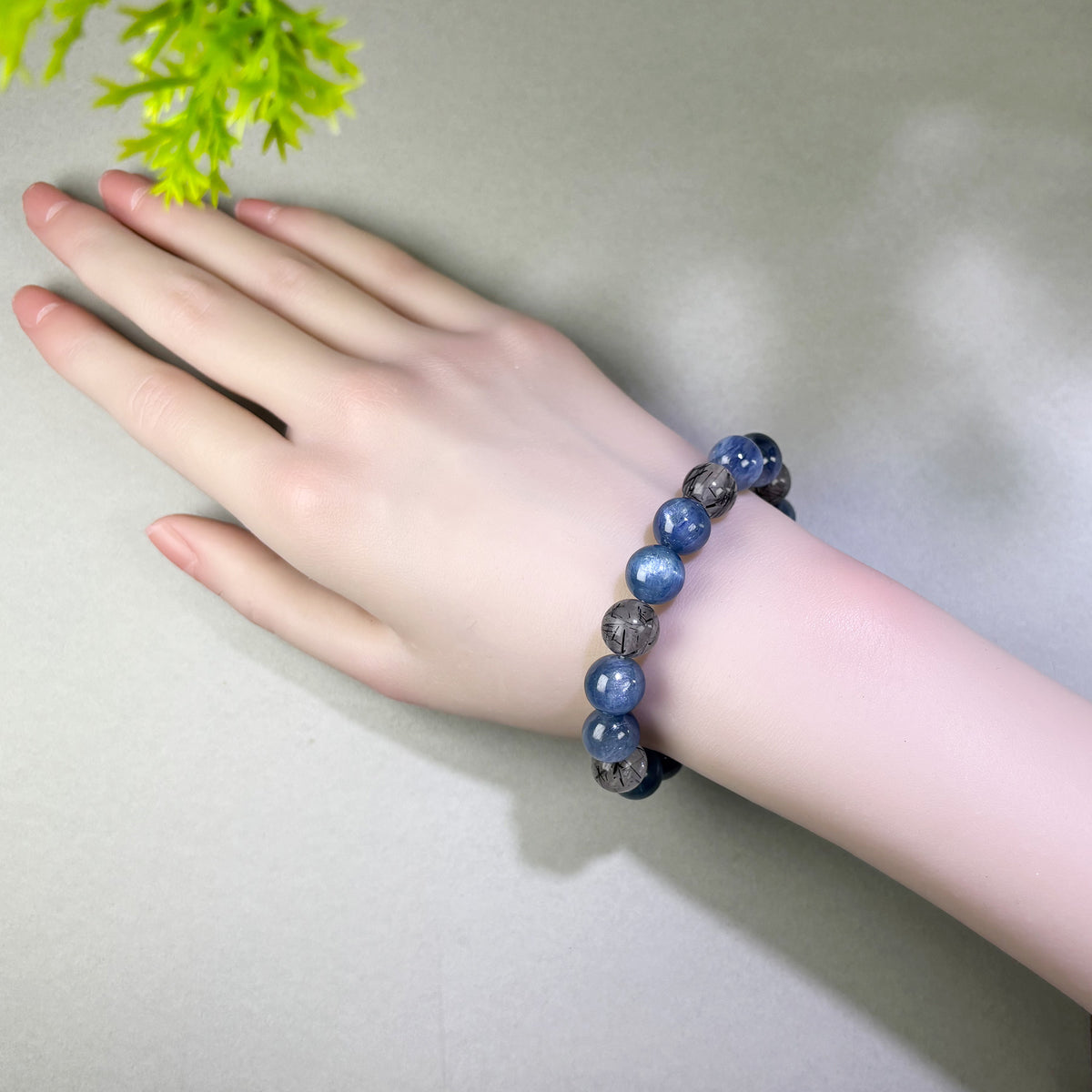 Blue Kyanite and Black Rutilated Quartz bracelet worn on wrist for expressing your position during difficult conversations