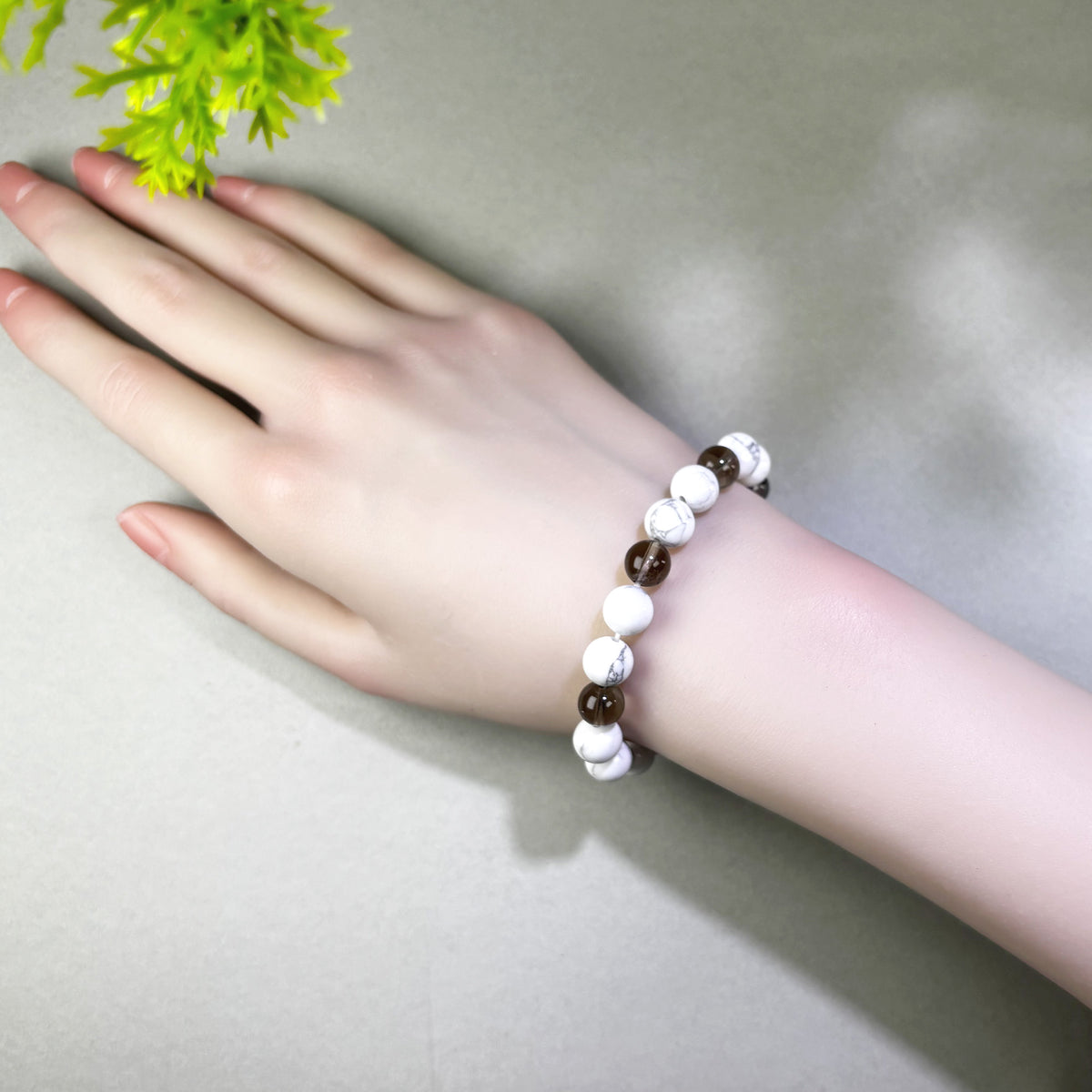 Howlite and Smoky Quartz bracelet worn on wrist for staying calmer and more grounded when stress builds