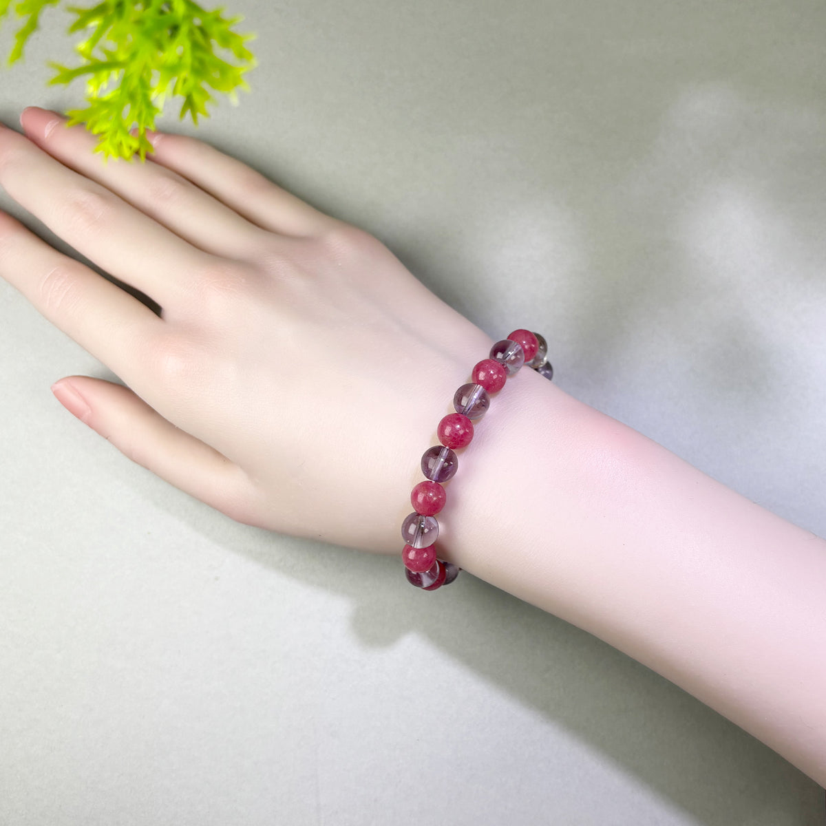 Amethyst and Rhodonite bracelet worn on wrist for calming repeated thoughts and working through past emotional hurt