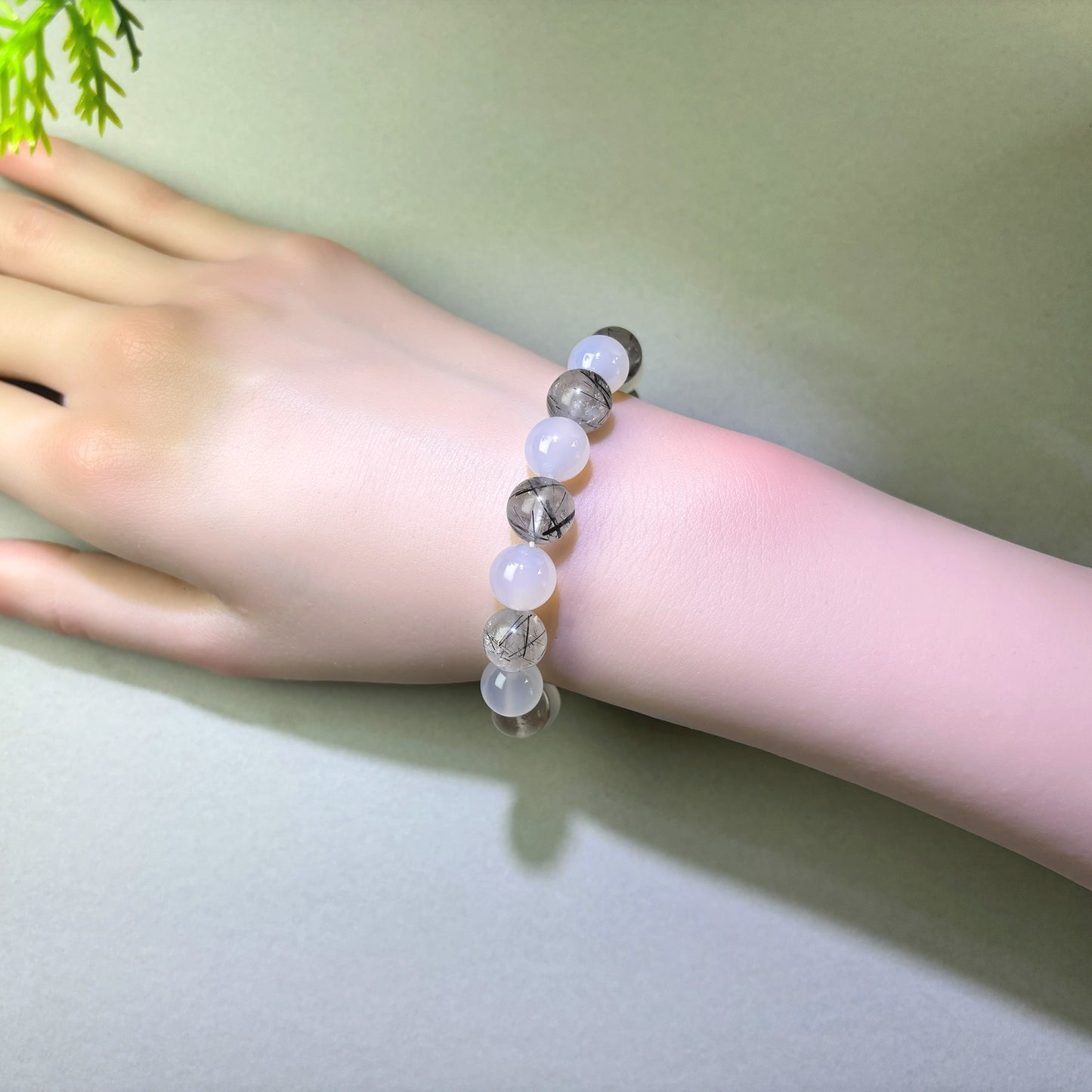 White Agate and Black Rutilated Quartz bracelet worn on wrist for clearer emotional separation and letting go of interactions
